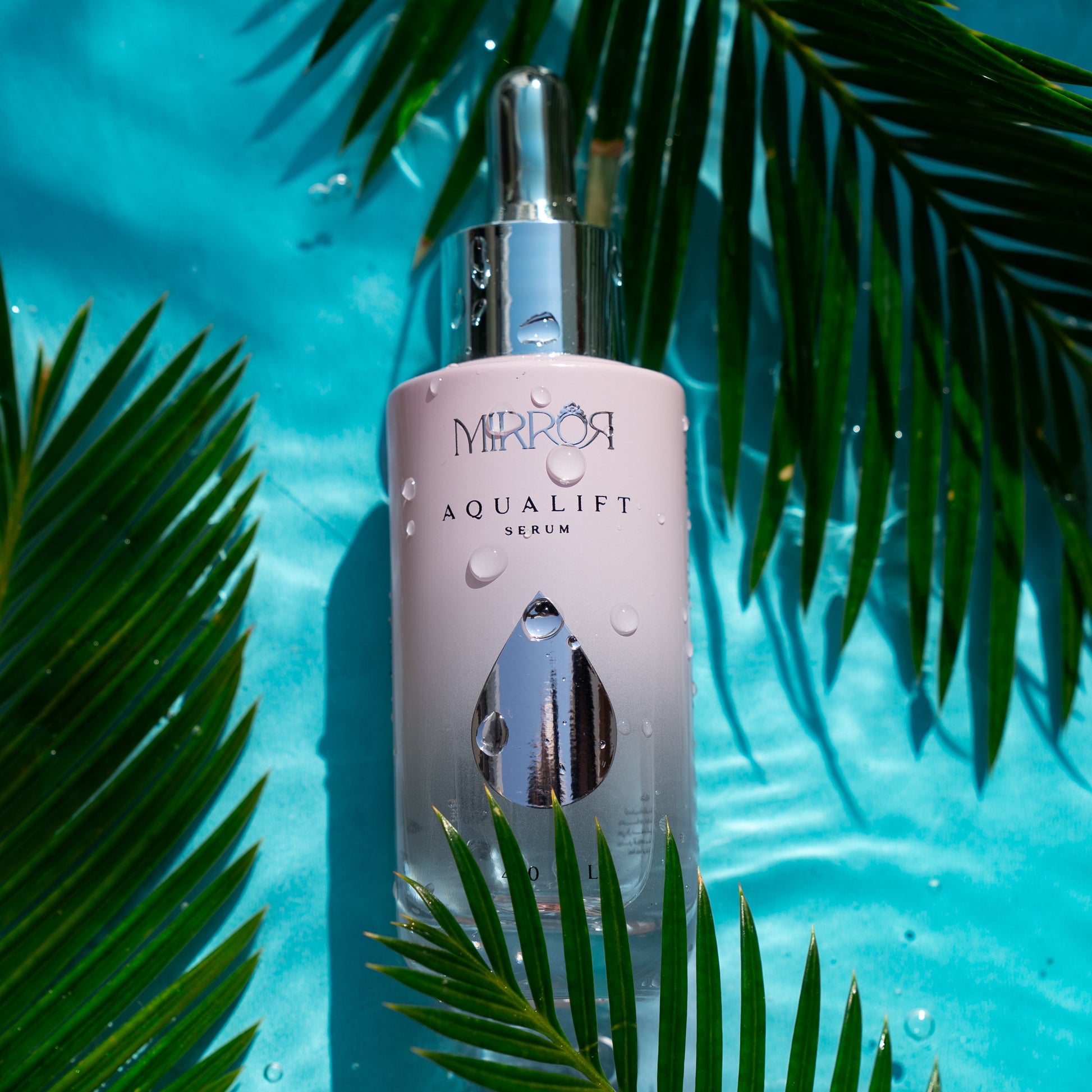 Mirror Skin Aqualift serum bottle surrounded by tropical palm leaves