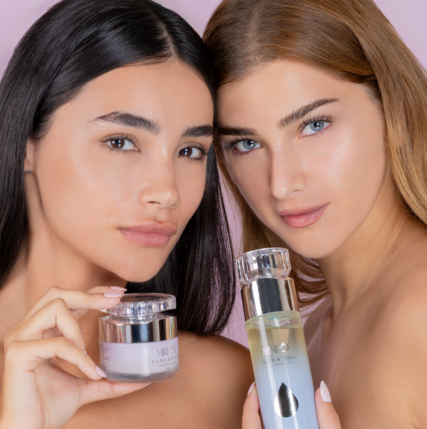 Two models with glowing skin holding Mirror Skin Cloudkiss Moisturizer and Risetone Toner against a pastel background.