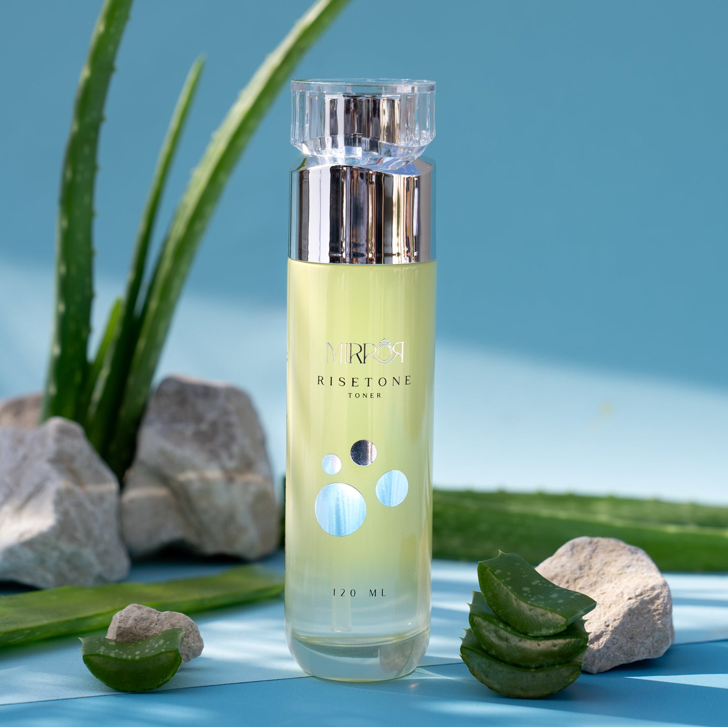 Mirror Skin Risetone Toner with aloe vera and rocks, symbolizing hydration and freshness.