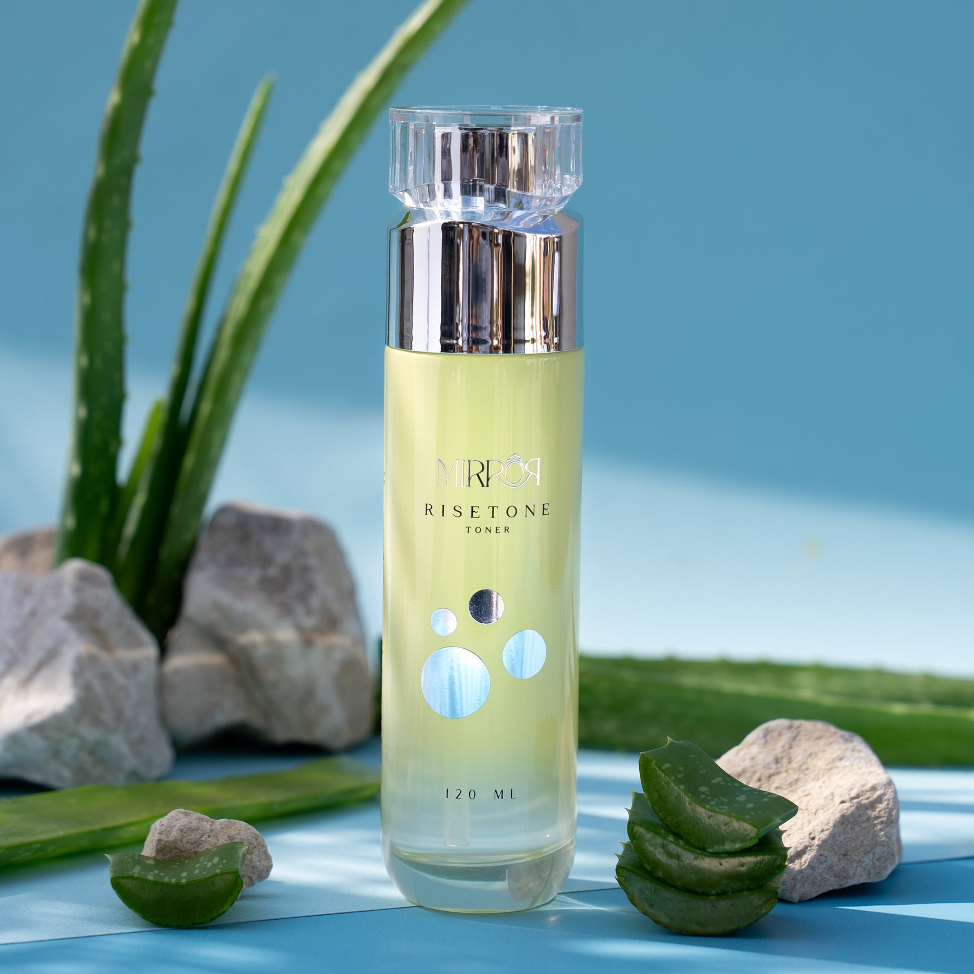 Mirror Skin Risetone Toner with aloe vera and rocks, symbolizing hydration and freshness.