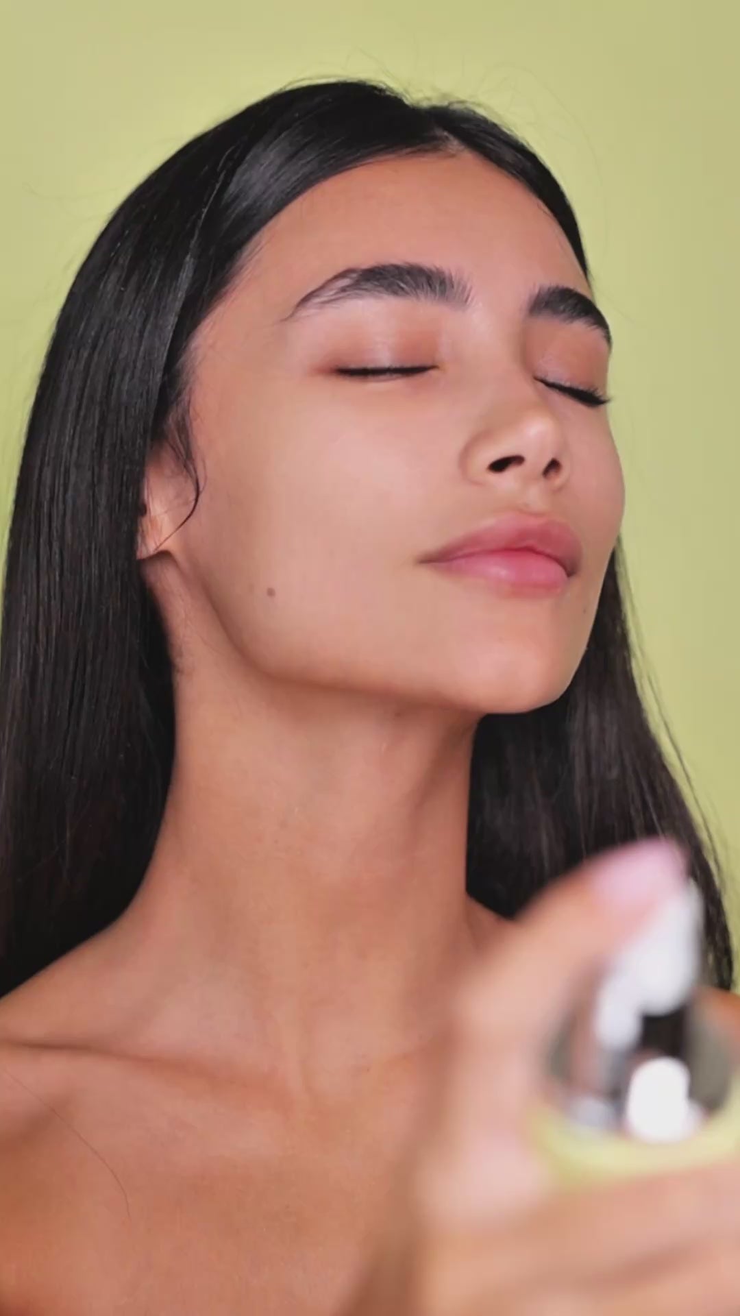 Model applying Mirror Skin Risetone Toner with a cotton pad on her cheek.